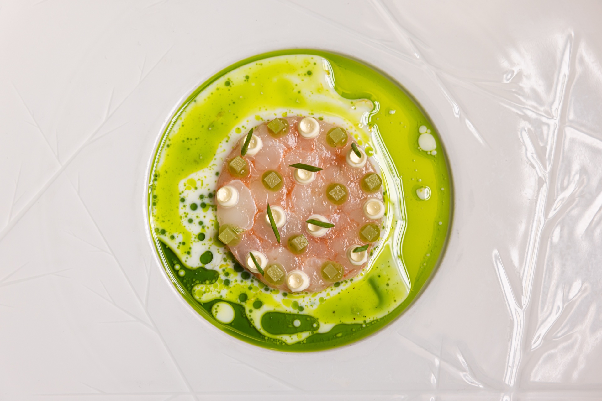 Refined fish dish with green herb oil